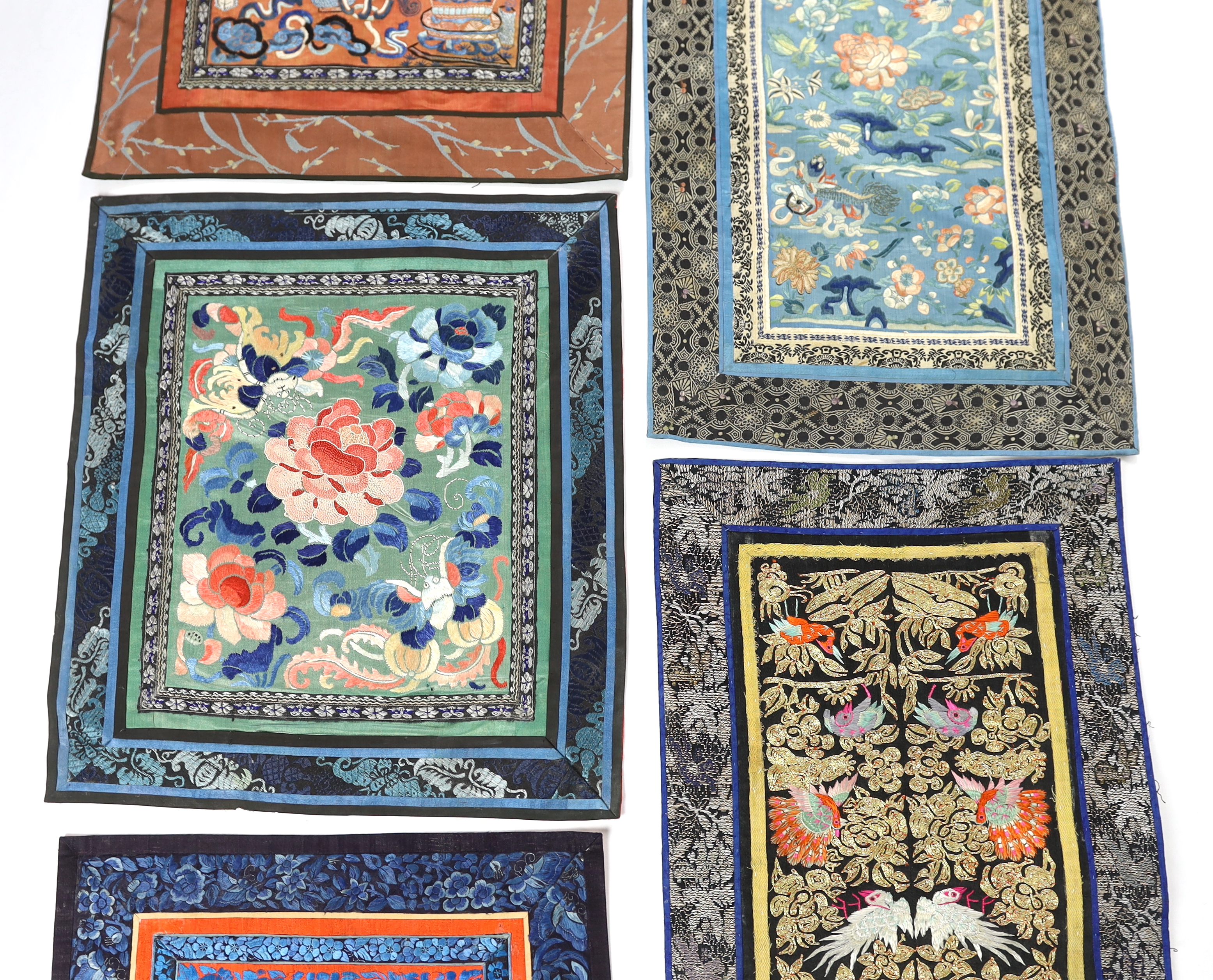 Five Chinese late Qing dynasty silk embroidered panels, two being embroidered with Beijing knot, a pair of metallic embroidered with phoenix sleeve bands, the other embroidered with butterflies and flowers, all five pane